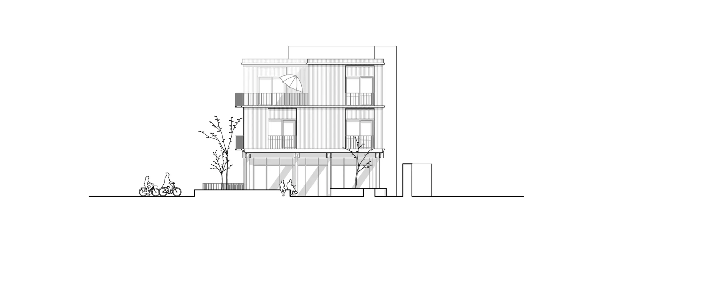 Ansicht von Süden eines dreigeschossigen Wohnhauses mit Balkonen und vorgelagerten Bäumen an der Straße.